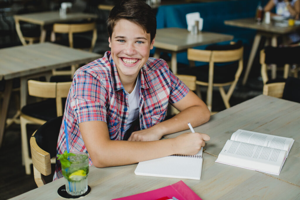 smiling-teen-with-studying-materials